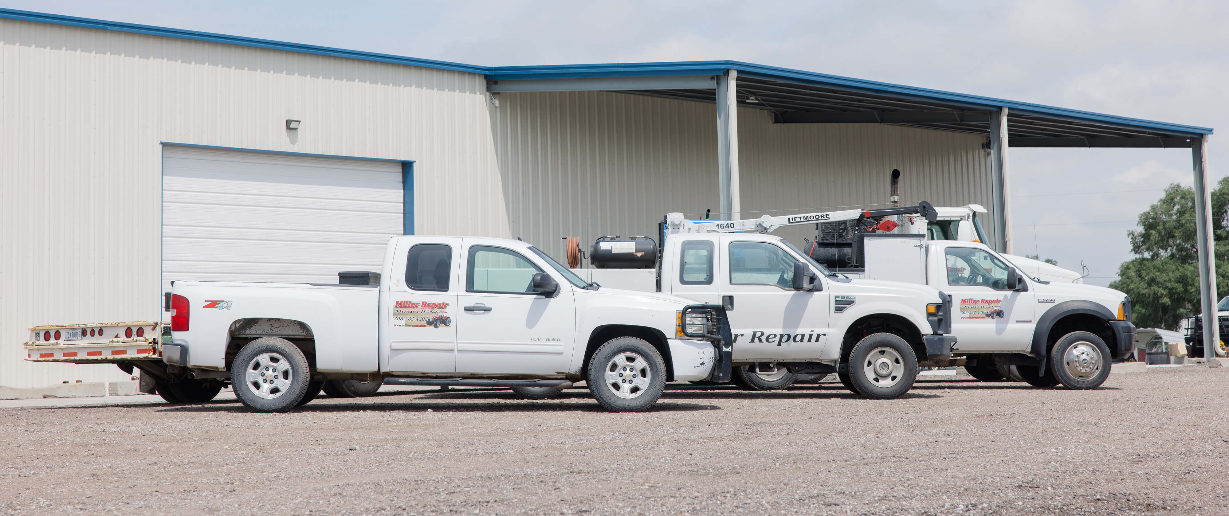 Three Miller service trucks outside of the building